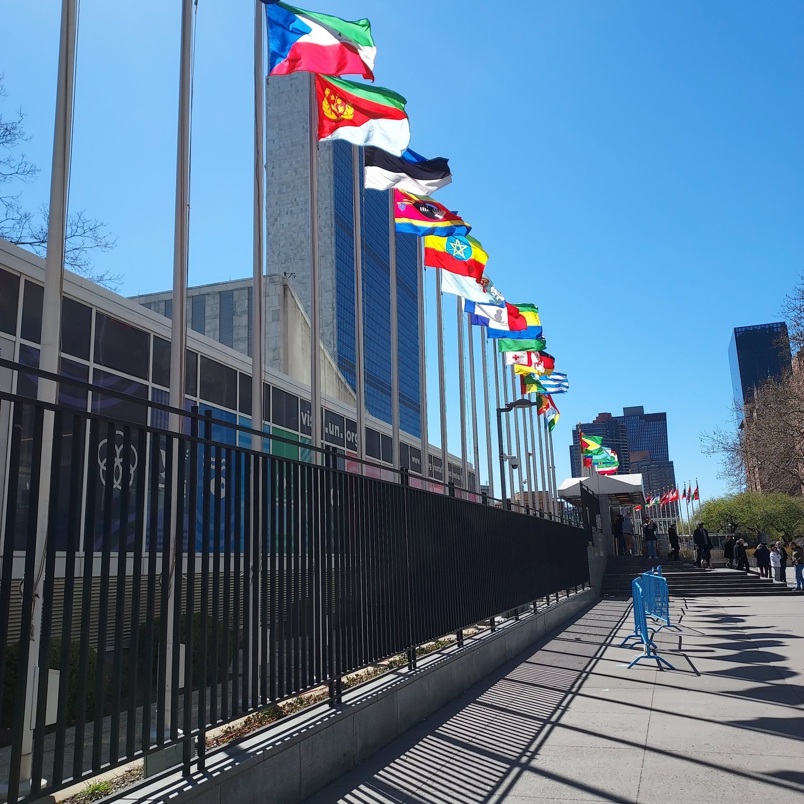 Flags of the nations lining the walkway to the United Nations headquarters in New York City